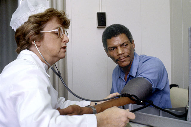 A nurse taking a man’s blood pressure