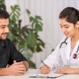 A man speaking with a female doctor